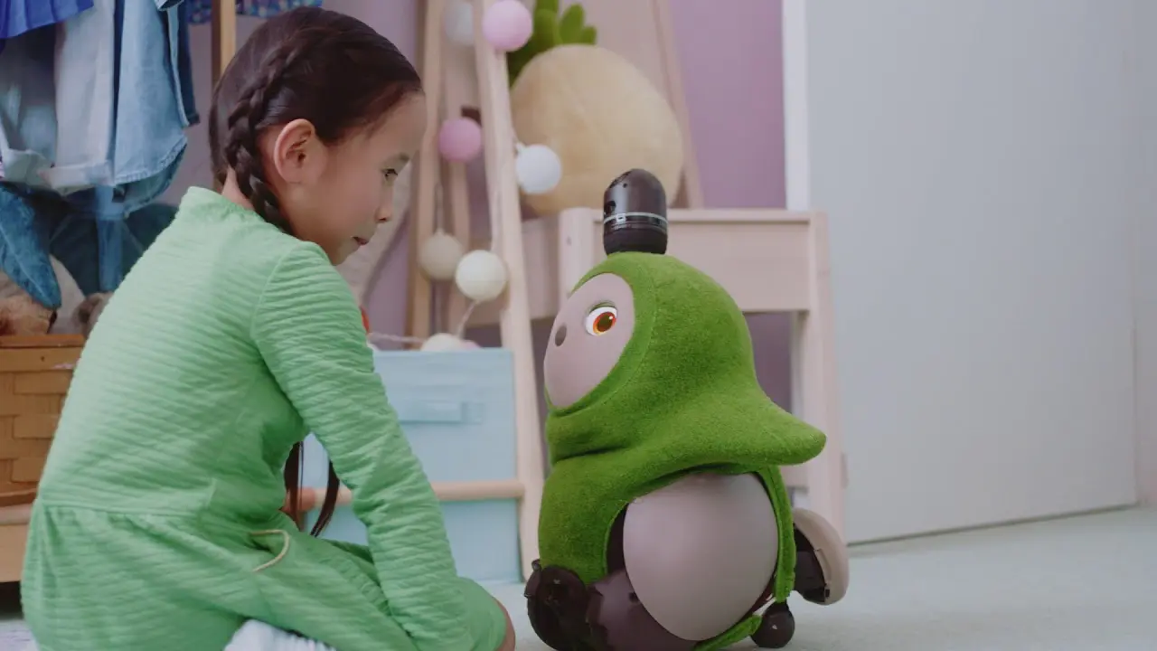 Robô-brinquedo interativo com luzes e tela no rosto ao lado de uma criança concentrada em um tablet, sugerindo a interação entre tecnologia e infância.