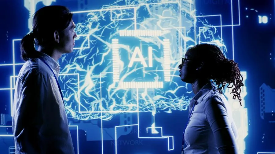 Mão humana e mão robótica se tocam, simbolizando a interação e o dilema entre a humanidade e a inteligência artificial.