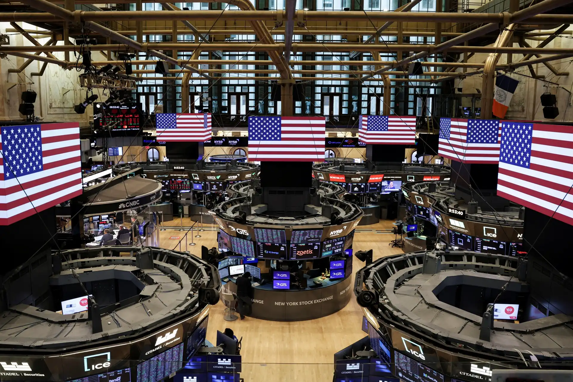 Análise de gráfico financeiro com setas indicando alta, refletindo o bom desempenho das ações americanas impulsionadas pela IA. Ao fundo, chips de computador.